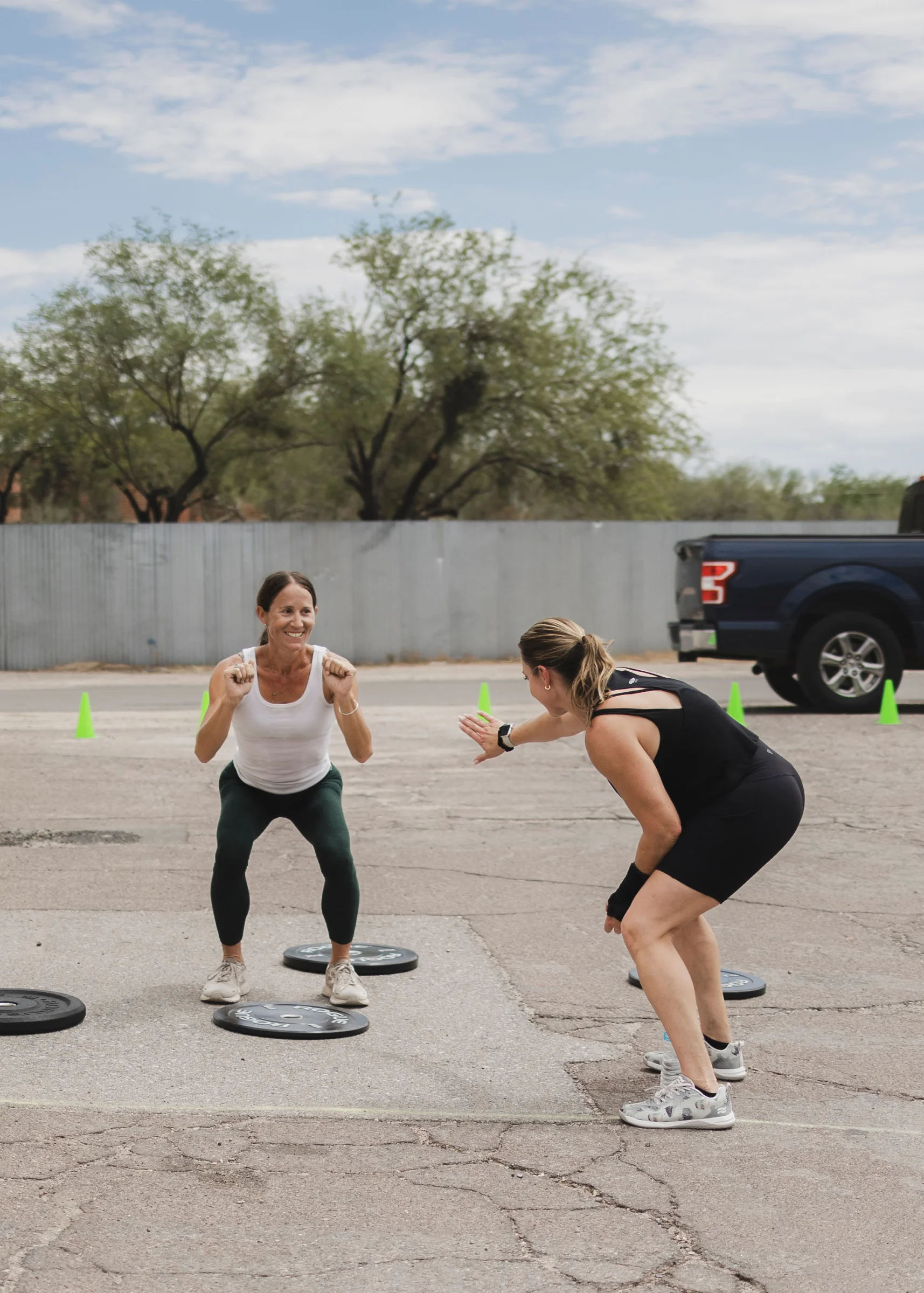 Personal trainer coaching a client at The Gym of Tucson outdoor training area